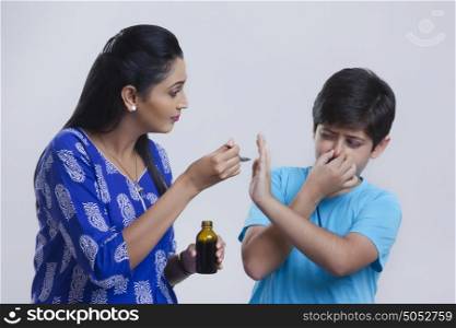 Son refusing to take medicine from mother