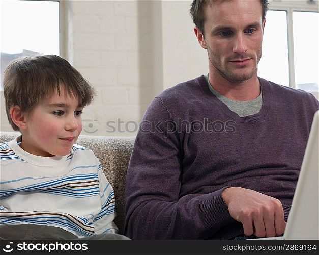 Son Watching Father Use Laptop