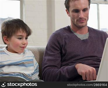 Son Watching Father Use Laptop