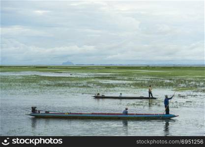 SONGKLA, THAILAND -MARCH 13 : Unidentified villagers in a boat do fishing in the waters on MARCH 3, 2016 in Songkla, Thailand. Fishing is a major activity of people living in the backwater region