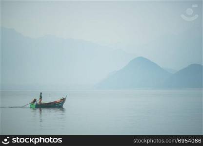 SONGKLA, THAILAND -MARCH 13 : Unidentified villagers in a boat do fishing in the waters on MARCH 3, 2016 in Songkla, Thailand. Fishing is a major activity of people living in the water region