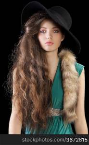 sophisticated elegant woman portrait with hair style and wearing a green dress and a tail fur , black hat