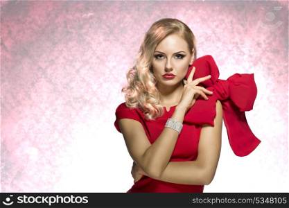 sophisticated lady in red dress with shining bracalet and elegant hair style looking in camera. keep the big bow