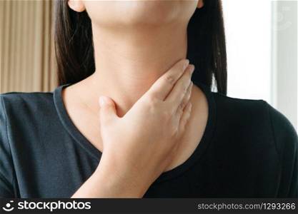 Sore Throat. Beautiful woman hand touching her pain neck. Woman healthcare concept