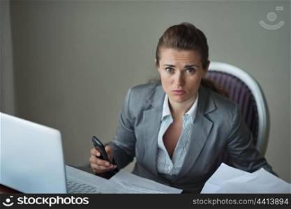 Sorrowful business woman working at desk