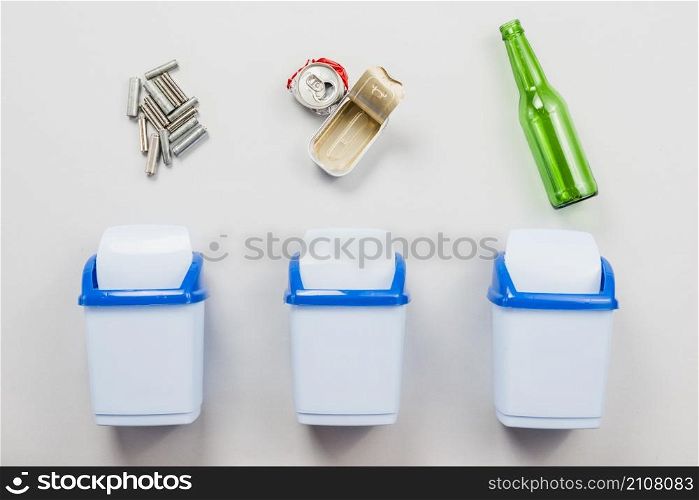 sorting trash into separate garbage cans