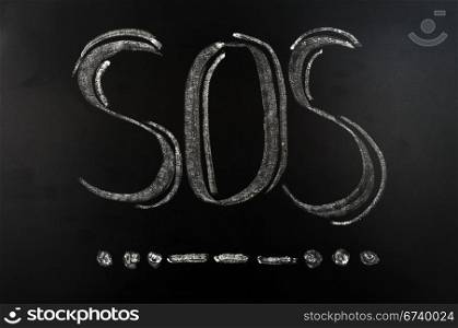 SOS international Morse Code distress signal written on a blackboard
