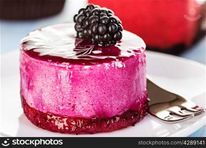 Souffle, cake berry, jelly on the wooden blue background