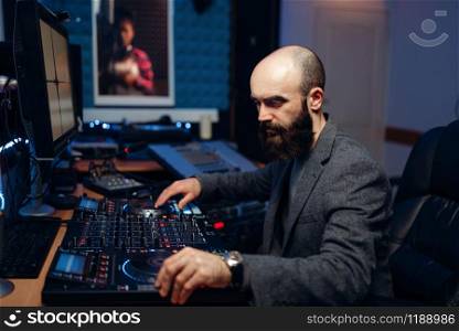 Sound engineer makes record of female singer in studio. Musician in headphones performs composition, professional music mixing. Sound engineer makes record of singer in studio