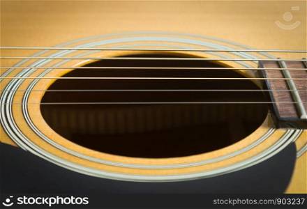 Sound Hole and Acoustic Guitar String and Pickguard and Fingerboard and Fret in Close Up View