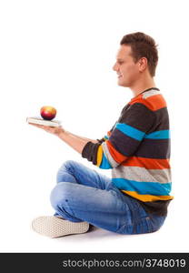 Sound mind in healthy body - concept of mental nutrition - man with book and apple white background