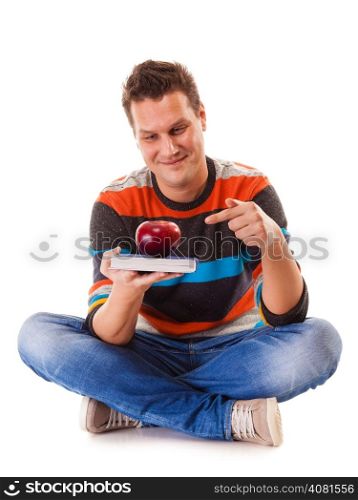 Sound mind in healthy body - concept of mental nutrition - man with book and apple white background
