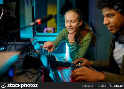 Sound producer mixing track with a child in recording studio. Sound producer mixing track with a child