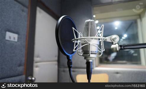 Sound production recording studio with microphone and shock mount and pop filter on tripod which use for vocalist or narrator or dj on brodcasting or professional creator live online channel