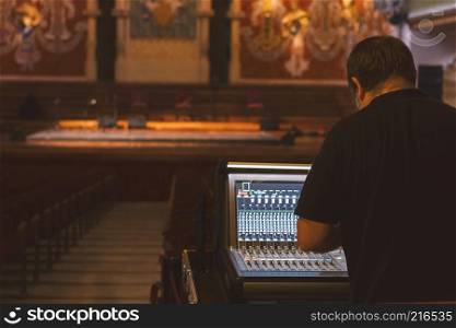 Sound technician at the console mixer for theater sound