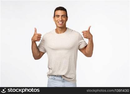 Sounds good. Assertive, optimistic handsome strong man showing thumbs-up. Young athlete agree with new training program, smiling happily, give positive reply, approve awesome idea, white background.. Sounds good. Assertive, optimistic handsome strong man showing thumbs-up. Young athlete agree with new training program, smiling happily, give positive reply, approve awesome idea, white background