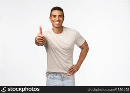 Sounds good, nice work, keep up. Optimistic handsome young hispainic muscline guy, wear casual t-shirt, show thumbs-up and smiling in approval, accept something, like product, recommend advertise.. Sounds good, nice work, keep up. Optimistic handsome young hispainic muscline guy, wear casual t-shirt, show thumbs-up and smiling in approval, accept something, like product, recommend advertise