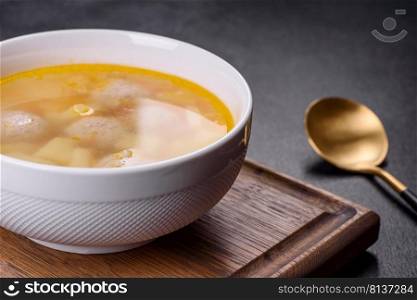 Soup with meatballs and vegetables. Vegetable soup with chicken and beans. Soup with turkey meatballs, potatoes and vegetables. Selective focus
