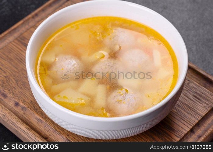 Soup with meatballs and vegetables. Vegetable soup with chicken and beans. Soup with turkey meatballs, potatoes and vegetables. Selective focus