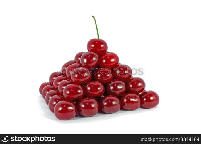 Sour cherries ordered in form of a pyramid isolated on white