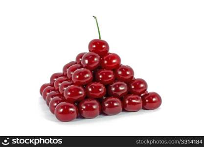 Sour cherries ordered in form of a pyramid isolated on white