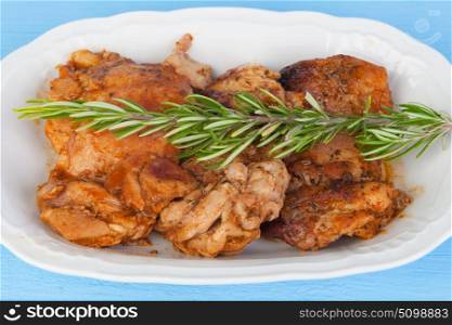 Source of chicken in sauce with a sprig of rosemary on top