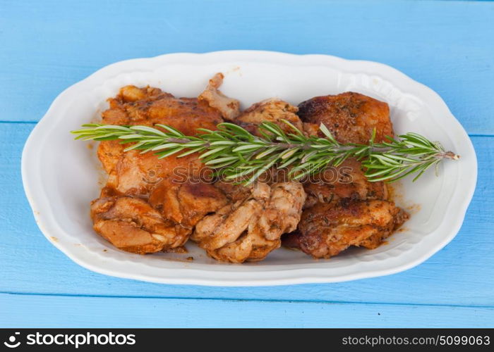 Source of chicken in sauce with a sprig of rosemary on top