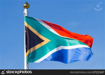 South African flag on the blue sky