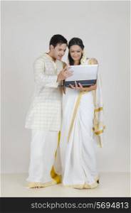 South Indian couple with a laptop