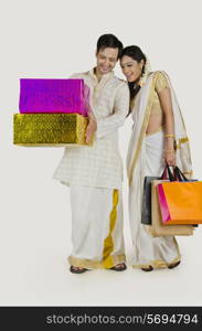 South Indian couple with shopping bags and gifts