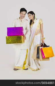 South Indian couple with shopping bags and gifts