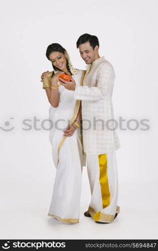 South Indian man showing wife jewelery