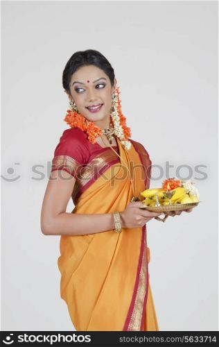 South Indian woman holding a thali