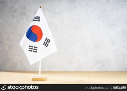 South Korea table flag on white textured wall. Copy space for text, designs or drawings