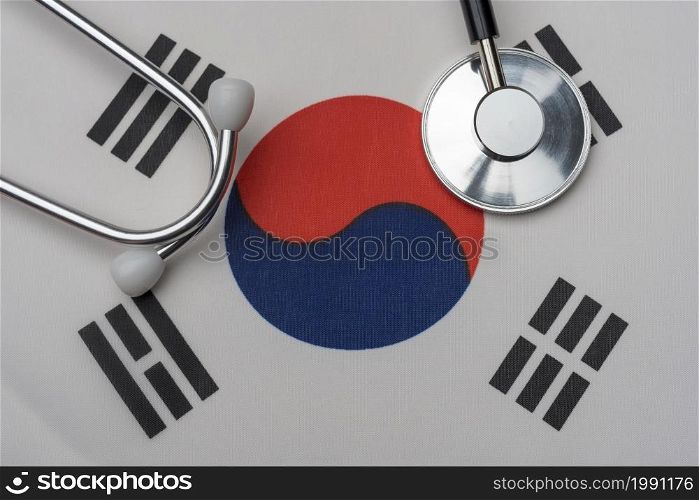 South Korean flag and stethoscope. The concept of medicine. Stethoscope on the flag in the background.. South Korean flag and stethoscope. The concept of medicine.