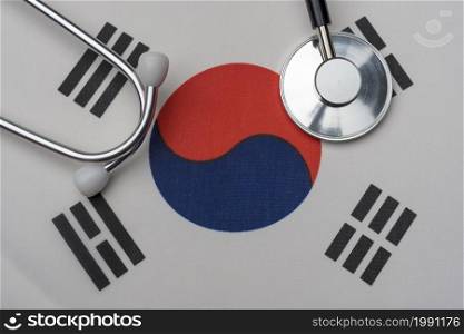 South Korean flag and stethoscope. The concept of medicine. Stethoscope on the flag in the background.. South Korean flag and stethoscope. The concept of medicine.