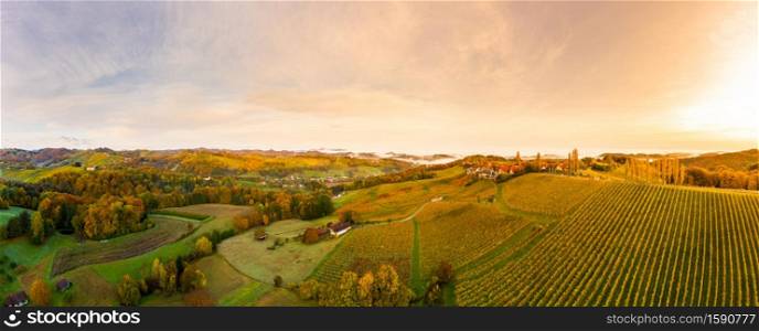 South styria vineyards panorama, Aerial view from Eckberg at Autumn grape hills and foggy Alps in distance.. Aerial panorama from Eckberg at Autumn grape hills and foggy Alps in distance.
