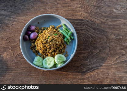 Southern Stir-Fried Pork with Yellow Curry Paste Served with Purple eggplant, Cucumber and Yard long bean. Top view, Copy space, Selective focus.