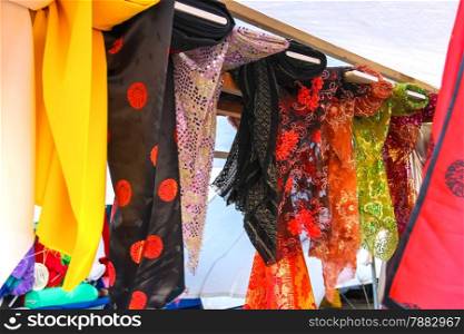 Souvenir scarves on a rack in outdoor sales