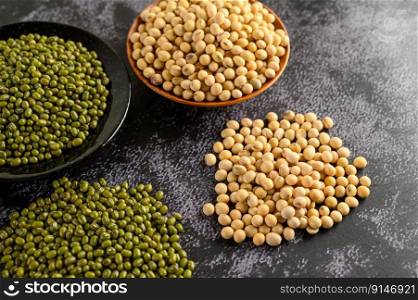 Soybean and Mung bean on a black cement floor background.