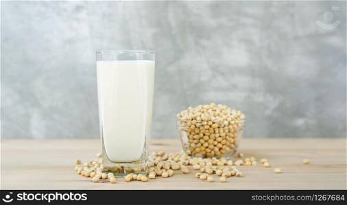 soybean in a bowl and soy milk on a wooden background.