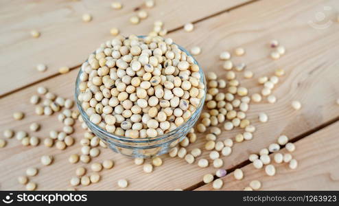 soybean in a bowl on a wooden background.