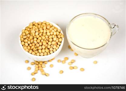 Soybean on bowl and soy milk in glass on white gray background / Milk healthy diet and natural bean protein