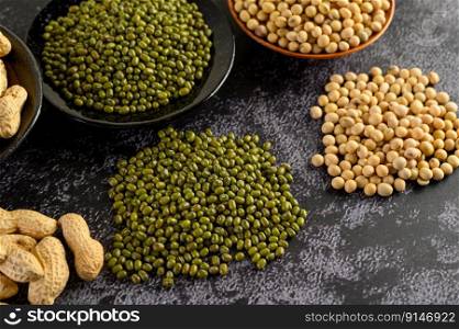  Soybean, peanut, and Mung bean on a black cement floor background. Selective focus.