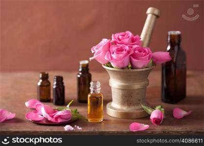 spa and aromatherapy set with rose flowers mortar essential oils