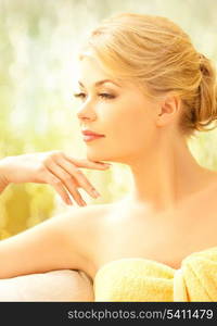 spa and beauty concept - beautiful woman covered with towel in spa salon