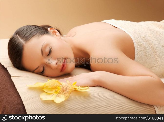 spa and beauty concept - woman in spa salon lying on the massage desk. woman in spa salon