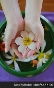 spa and beauty female hand and flower in water