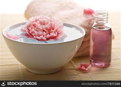 spa and body care - towel and flower in bowl