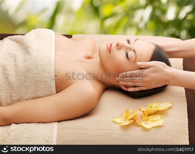 spa and holidays - woman in spa getting facial massage